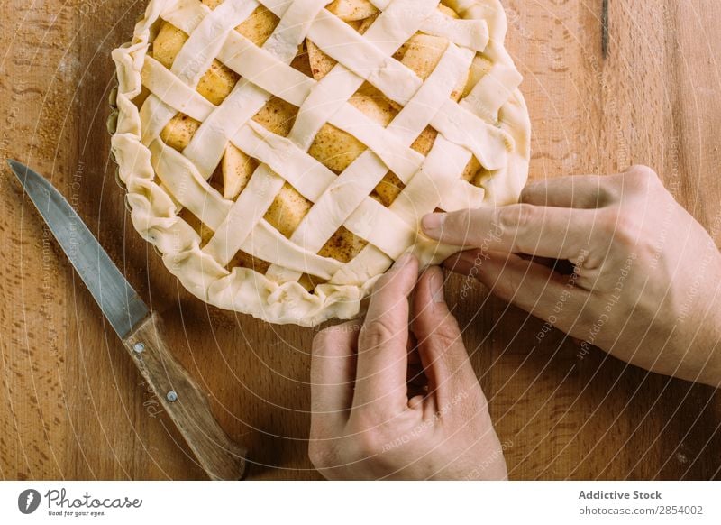 Preparation of an apple pie on wooden table american autumn bakery cake cinnamon dessert fall flour food fresh fruit golden hand homemade knive overhead pastry