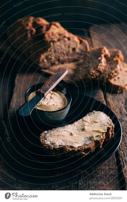 Rustic bread with butter Baking Bakery Bread Butter carbohydrate Dark Flour Food Fresh home-baked loaf Moody Spread Wheat Wood