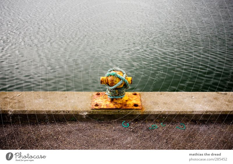 ONCE PLEASE FASTEN Port City Deserted Harbour Authentic Bollard Drop anchor Rope Knot Yellow Rust Calm Line Edge Ocean Waves Water Colour photo Multicoloured