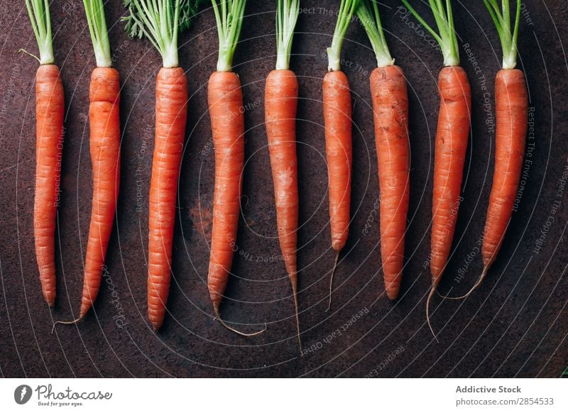 Bunch of fresh carrots in dark metallic background Background picture Carrot Multicoloured Dark Food Fresh Harvest Healthy Metal Nutrition Orange Organic Raw