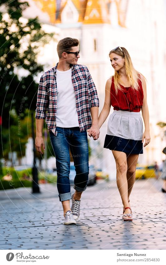 Romantic Young Couple Walking in the City. Relationship Love Youth (Young adults) Happy Laughter Smiling Human being Summer Street Europe Together Caucasian