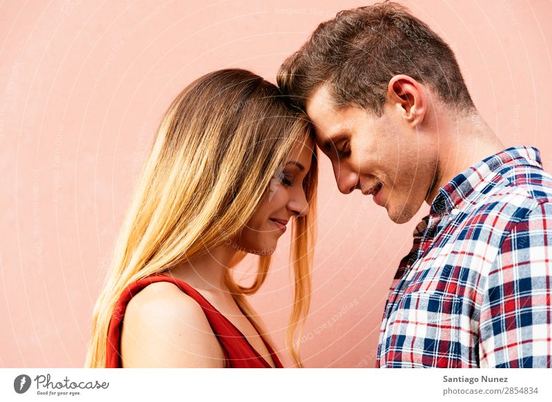 Young loving couple hugging in the street. Couple Love Woman Relationship Youth (Young adults) Beautiful Embrace Romance Happiness Kissing romantic Smiling