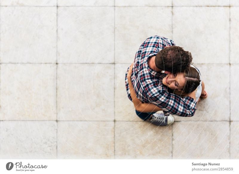 Young loving couple hugging in the street. From top view. Couple Love Woman Relationship Youth (Young adults) Beautiful Embrace Romance Happiness Kissing