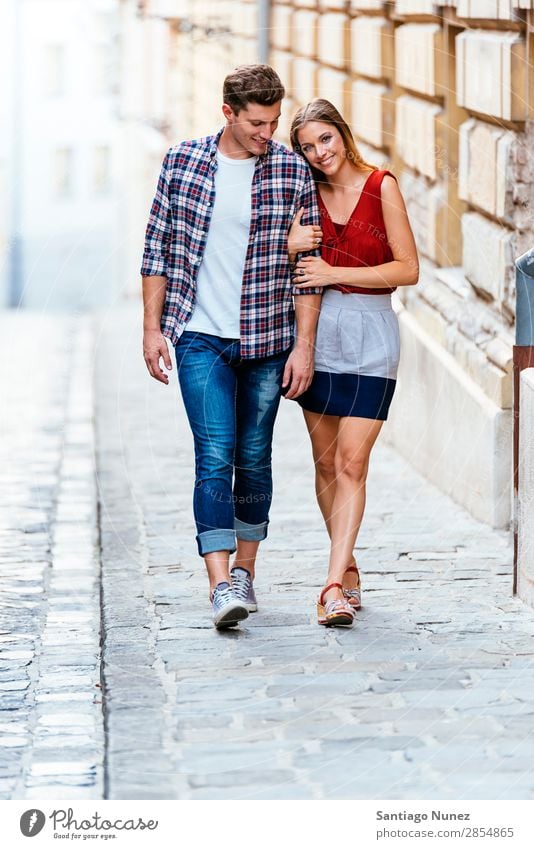 Romantic Young Couple Walking in the City. Relationship Love Youth (Young adults) Happy Laughter Smiling Human being Summer Street Europe Together Caucasian