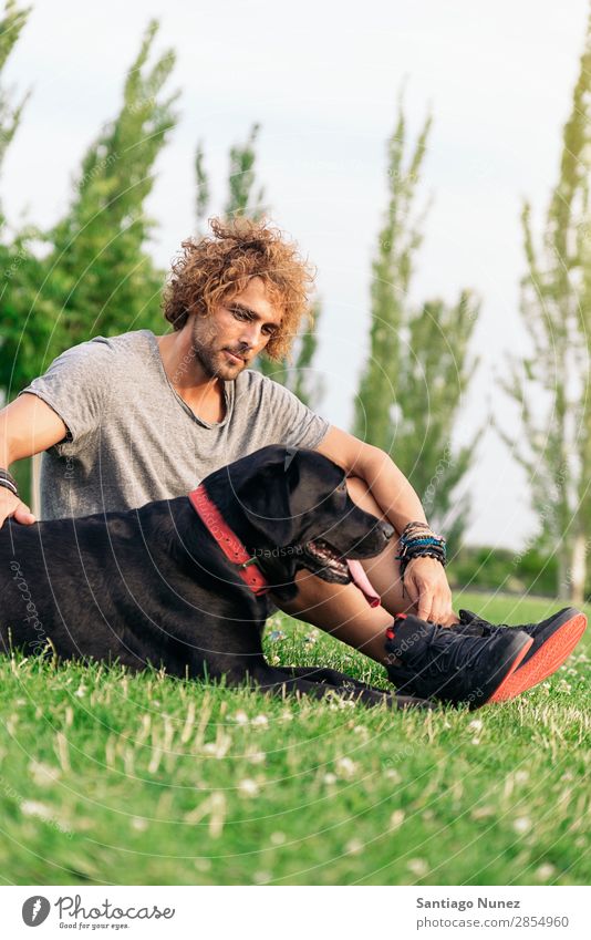 Man having fun with his dog. Dog Pet Park owner Human being Green Leash Walking Animal Running Happy Action Adults Caucasian Friendship Joy Grass Guy handsome