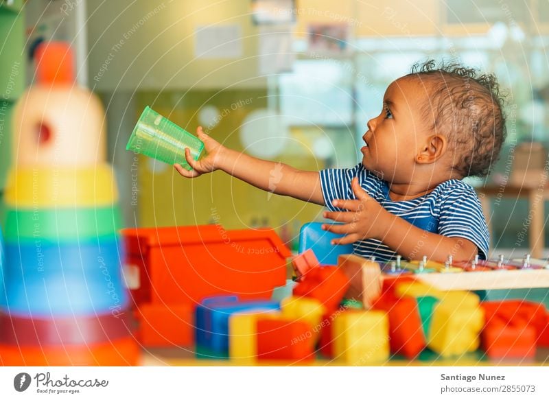 Happy baby wants water. Baby Playing childcare Kindergarten School Toys Toddler Girl Small Child blocks Considerate Story Cute Joy Preschool Lifestyle Education