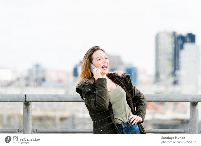 Beautiful woman at phone in the city. Telephone Woman City To talk Street Easygoing Mobile Youth (Young adults) Smart Background picture Happy speaking