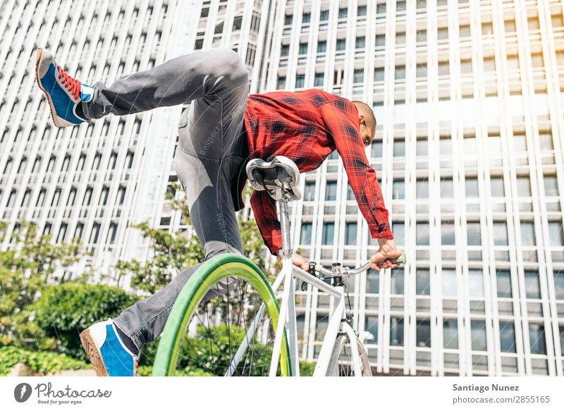 Handsome young man on bike in the city. Man Bicycle fixie Hipster Lifestyle Cycling City Solar cell Town Human being handsome Style Street Portrait photograph