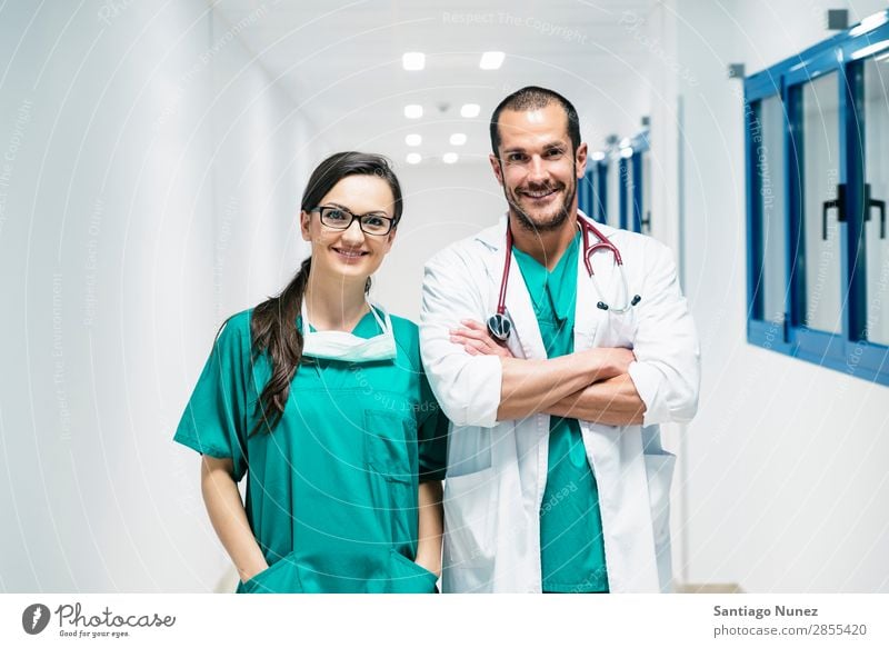 Smiling doctor and nurse portraiture. clinic Self-confident coworker Doctor examining Woman Girl Hand Happy Healthy Health care Hospital Interior shot