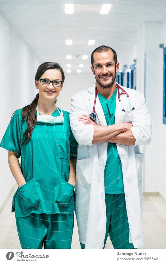 Smiling doctor and nurse portraiture clinic Self-confident coworker Doctor examining Woman Girl Hand Happy Healthy Health care Hospital Interior shot Profession