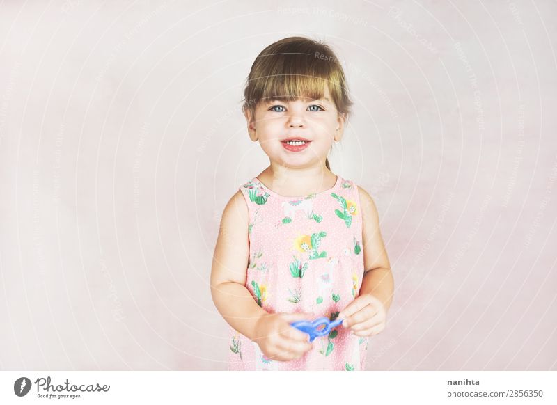 Young little and funny girl in a studio shot Lifestyle Joy Happy Face Child Human being Feminine Toddler Girl Infancy 1 1 - 3 years Dress Blonde To enjoy