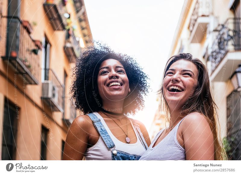 Beautiful women having fun in the street. Woman Friendship Youth (Young adults) Happy Summer Portrait photograph Human being Joy Smiling Walking Racism Adults