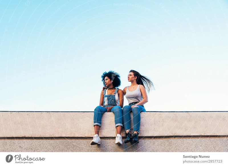 Beautiful women seating in the street. Woman Friendship Youth (Young adults) Earnest Summer Human being Joy Sit Adults Girl pretty 2 Couple Homosexual Together