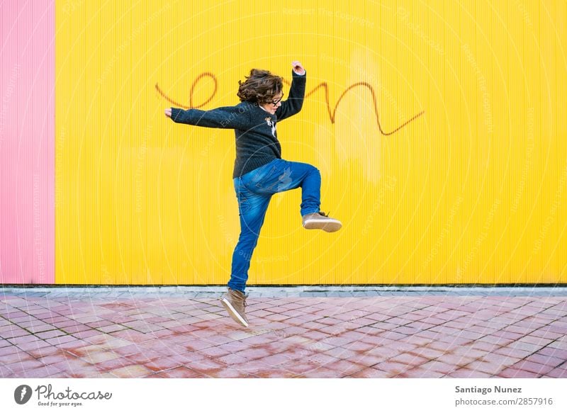 Happy boy jumping. Jump Boy (child) Child Excitement Style Youth (Young adults) Street Town Freestyle Background picture City Man Model Lifestyle Exterior shot