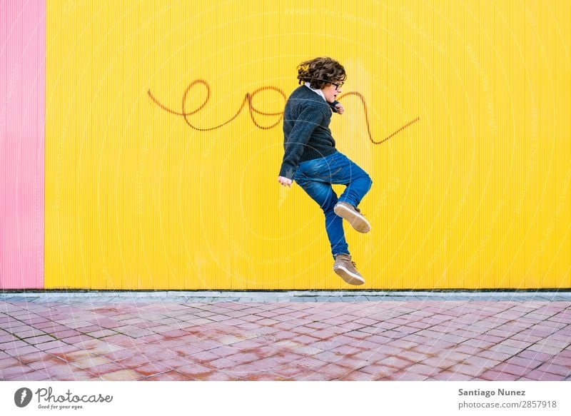 Happy boy jumping. Jump Boy (child) Child Excitement Style Youth (Young adults) Street Town Freestyle Background picture City Man Model Lifestyle Exterior shot