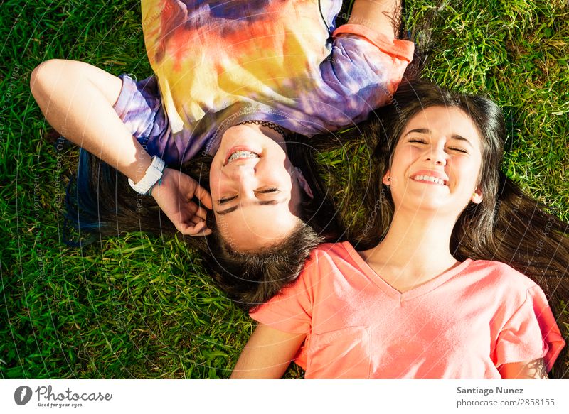 Beautiful Teenage Girls Having Fun in Summer Park. Outdoor braket Caucasian Cheerful Child Daughter Woman Friendship Joy Funny Grass Green Happy Embrace