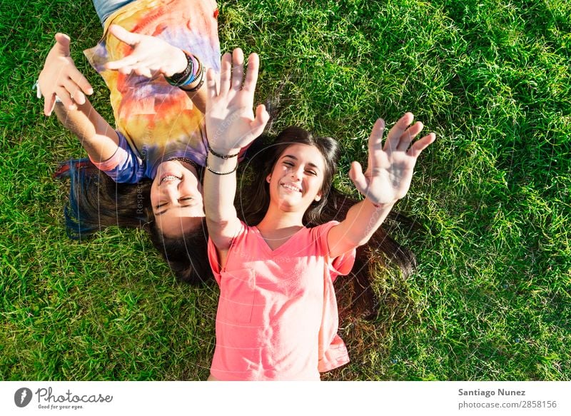 Beautiful Teenage Girls Having Fun in Summer Park. Outdoor braket Caucasian Cheerful Child Daughter Woman Friendship Joy Funny Grass Green Happy Embrace