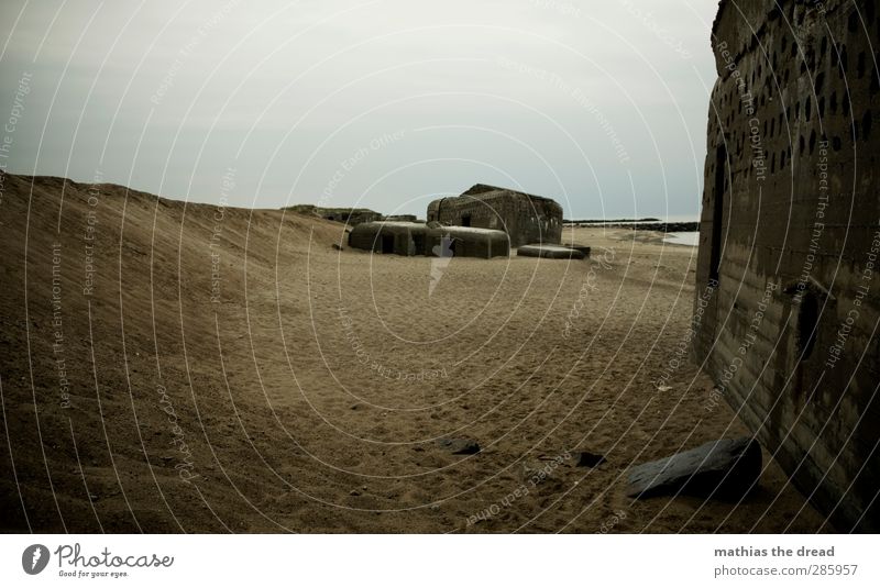 bunkers Sky Clouds Horizon Bad weather Rain Beach Deserted Ruin Manmade structures Building Architecture Aggression Old Threat Dark Sharp-edged Historic Strong