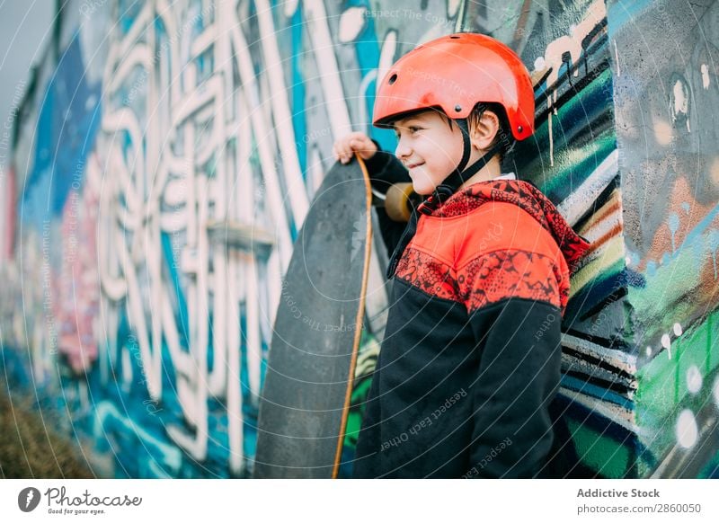 Kid with long board Board Boy (child) Caucasian Court building Graffiti Helmet learn Longboard Exterior shot Park Playing Protection Ice-skates Skateboard