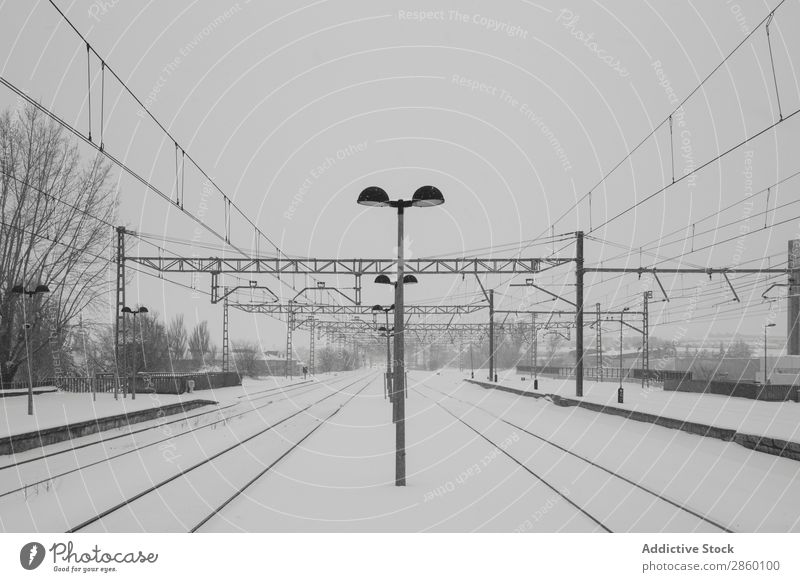 Railroad in snowy landscape Antique Cold Frost Frozen Industrial Exterior shot Platform Retro Snow snowing Station Train station Transport Vehicle Weather White