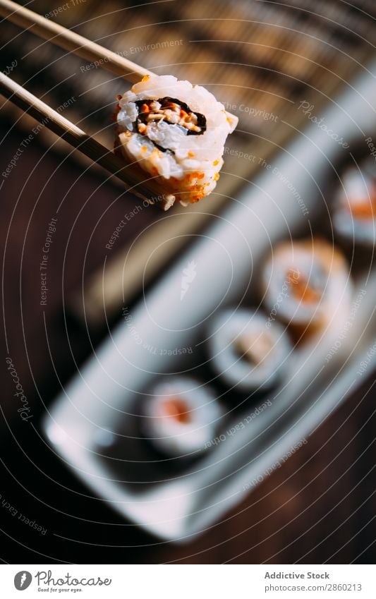 Sushi maki rolls and sashimi on a wooden background asian Avocado Chopstick Dish Fish Food Ginger Japanese nigiri nori Raw Rice Salmon Seafood soy sauce Table