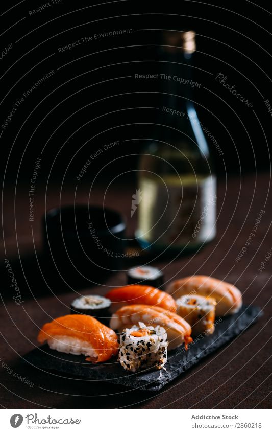 Sushi maki rolls and sashimi on a wooden background asian Avocado Chopstick Dish Fish Food Ginger Japanese nigiri nori Raw Rice Salmon Seafood soy sauce Table