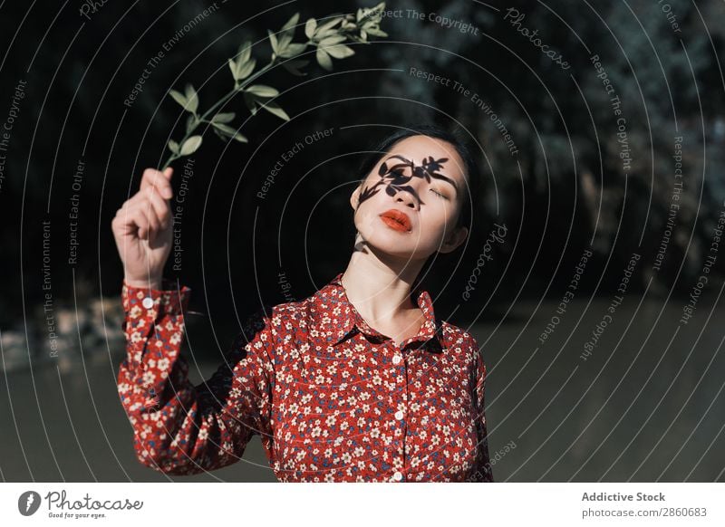 Asian woman with branch shadow on face Woman Youth (Young adults) Attractive Dress Red asian Japanese Branch Shadow Face Pond Nature Park closing face