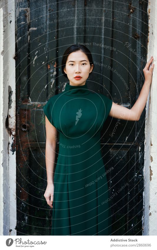 Asian woman leaning on wall Woman Youth (Young adults) Attractive Dress Green asian Japanese Wall (building) Lean Looking into the camera hiding Beautiful