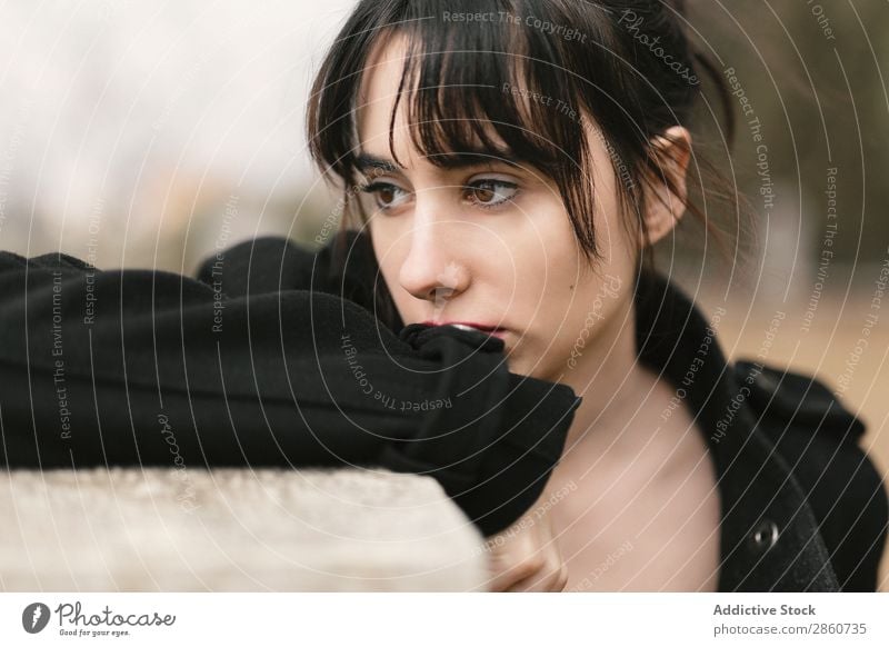 Melancholic woman in black leaning on fence Woman To enjoy Pensive Sadness Brunette Sensitive Fence Lean Dream Beautiful tender Remote tranquil