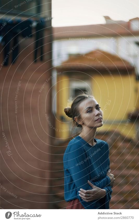 Woman standing at handrail in city pretty Youth (Young adults) Stand Handrail Lean Roof Town Think Pensive Beautiful Attractive Human being Beauty Photography