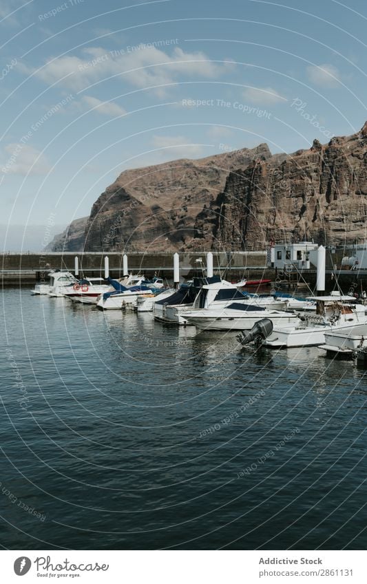 Small boats moored on pier Motorboat Jetty Vacation & Travel Sail Nature Landscape Tourism coastal Cliff Hill Town Vessel Beautiful Dock Water Drop anchor