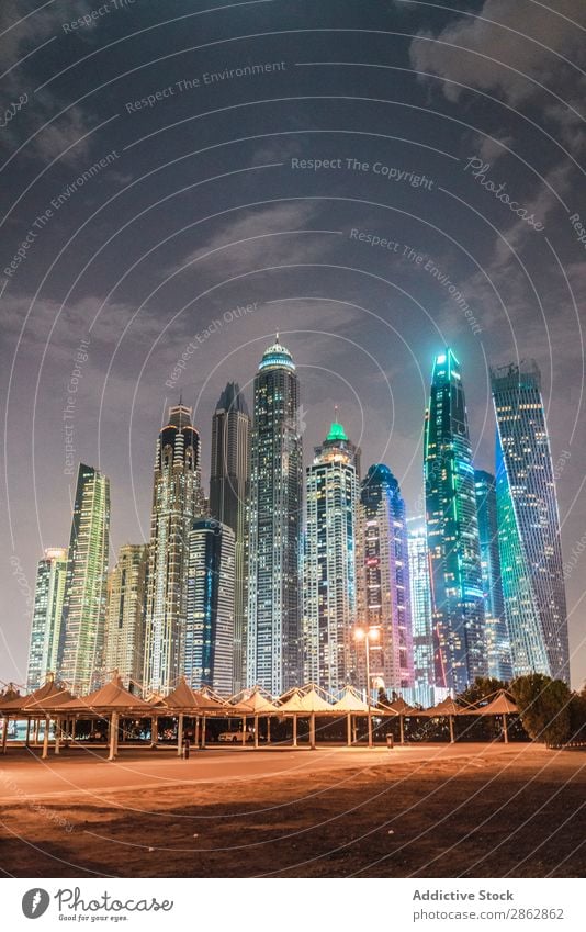 Cloudy sky over illuminated metropolis High-rise City Illuminate Evening Sky Clouds Dubai Architecture Town Skyline Downtown Modern Vacation & Travel Trip