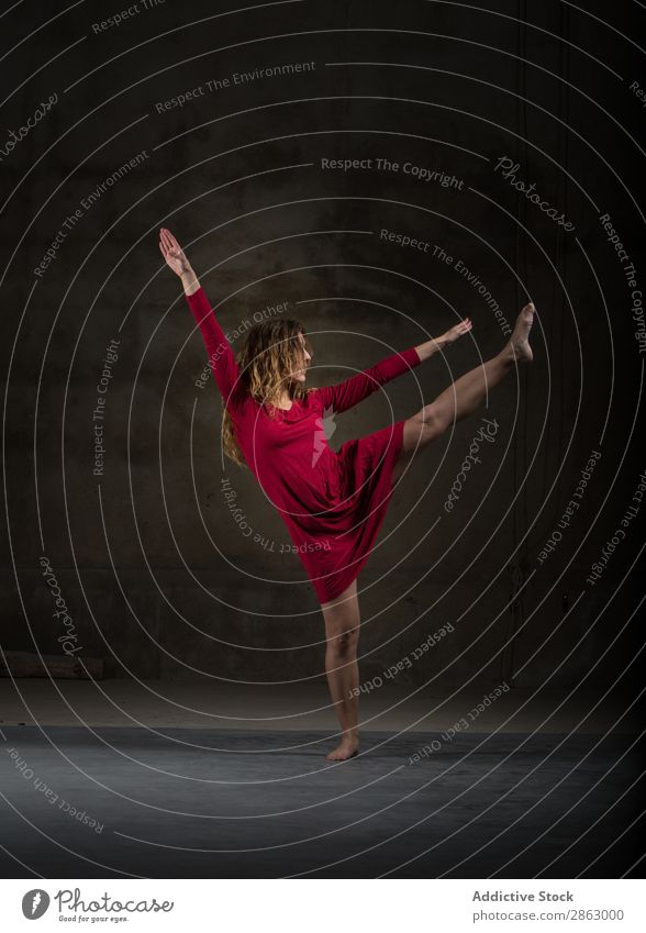 Young woman with upped leg in darkness Ballet Ballerina Dance Dress Woman Legs Hand Performance Room Red Elegant Dark Art pose Shows Smock obscurity grace