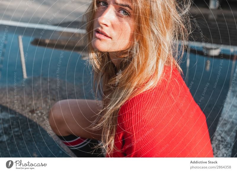 Charming woman in sweater on street between puddles Woman Street Puddle Sweater Lady To enjoy knee sock slop Youth (Young adults) Model Red Water