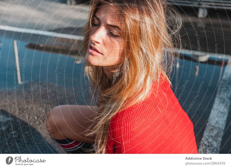 Charming woman in sweater on street between puddles Woman Blonde Street Puddle Sweater Lady To enjoy knee sock slop Youth (Young adults) Model Red Water