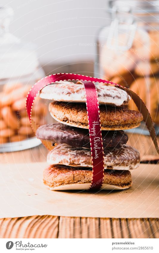 A few gingerbread cookies wrapped in red on wooden table Dessert Nutrition Eating Diet Happy Table String To enjoy Delicious Brown Christmas Baking Bakery