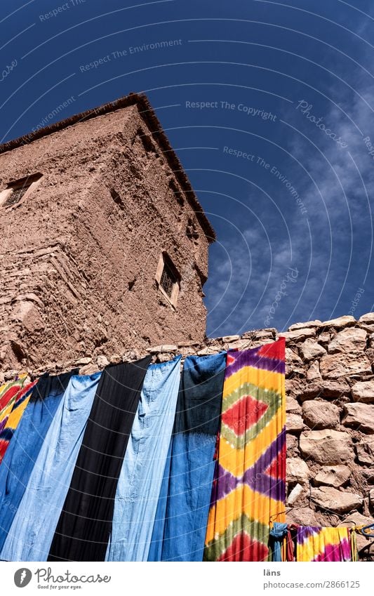 City wall with Berber cloths Town House (Residential Structure) variegated Deserted Architecture Wall (building) Facade Manmade structures Old Historic Morocco