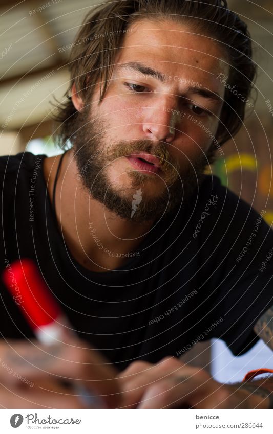 apply a red pencil Man Human being Young man Write Pen Red Draw Painting (action, artwork) Crayon Felt-tipped pen Sit Table Portrait photograph Media designer