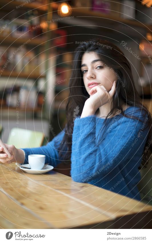 Young woman drinking coffee in urban cafe. Breakfast Coffee Tea Style Beautiful Hair and hairstyles Telephone PDA Camera Human being Feminine