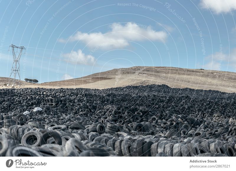 Heap of old tires between field Tire Field huge Car Accumulation Old Sky Beautiful weather Clouds Meadow Rubber Black Stack Second-hand Wheel dump Trash Nature