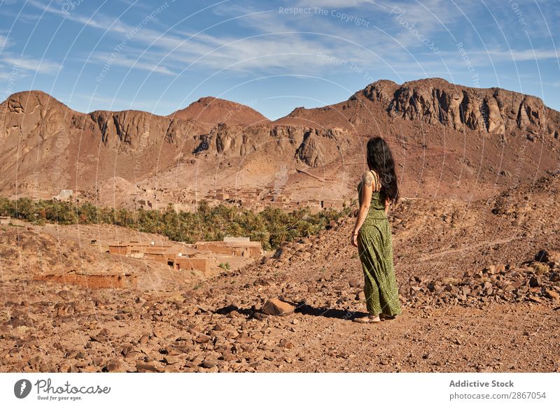 Woman between desert near mountains Desert Mountain Marrakesh Morocco Construction Landing Lady Youth (Young adults) Hill Brunette Ancient Old Building