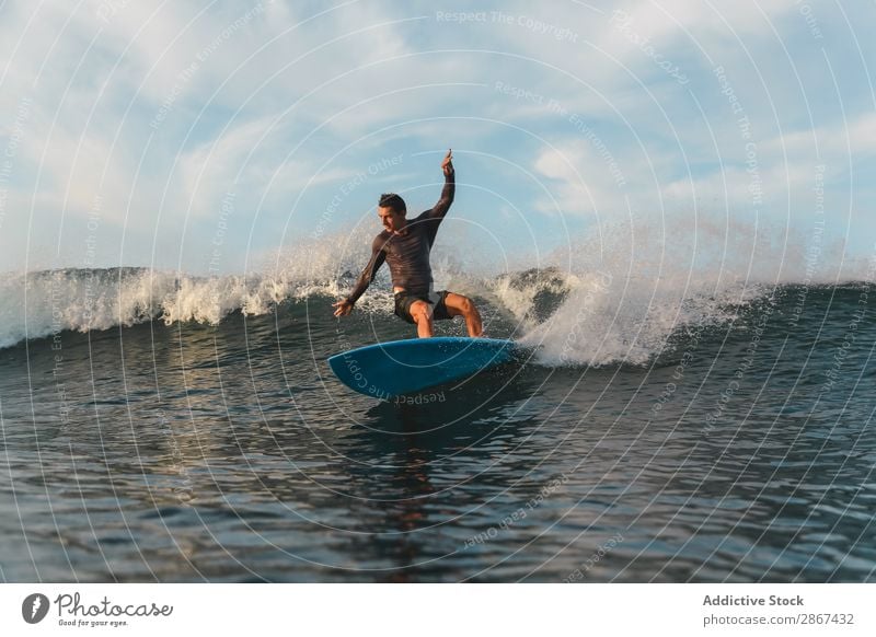 Man on surf board on waving water Surfboard Water Surface Sports Bali Indonesia Splash Surfing Wave Sky Ocean Heaven Evening Balance Ripple Landscape