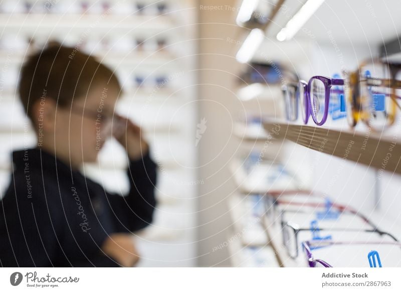 Young boy trying on glasses Boy (child) Child Eyes eyewear Fashion Person wearing glasses Lens ophtalmologist Optician optometrist optometry Looking Sunglasses