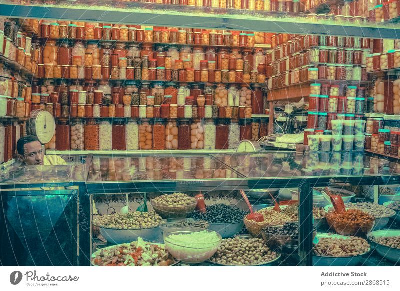 Man at counter with pickles Markets Pickles seller Food Shopping Organic Olive jar Vegetarian diet Agriculture pickled Vegetable Street Sale