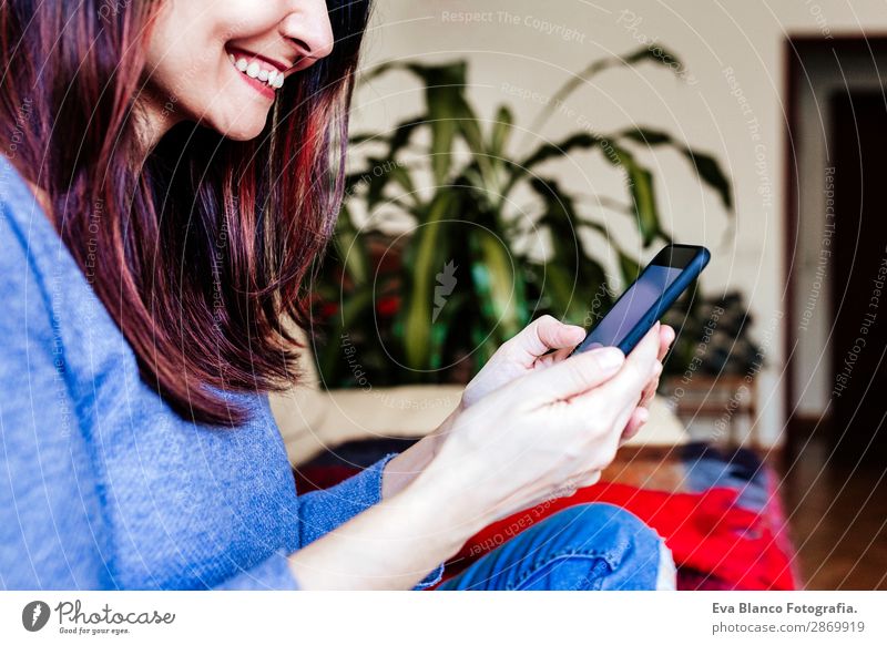 young woman sitting at home sofa using mobile phone Lifestyle Design House (Residential Structure) Sofa Work and employment Workplace Office Financial Industry