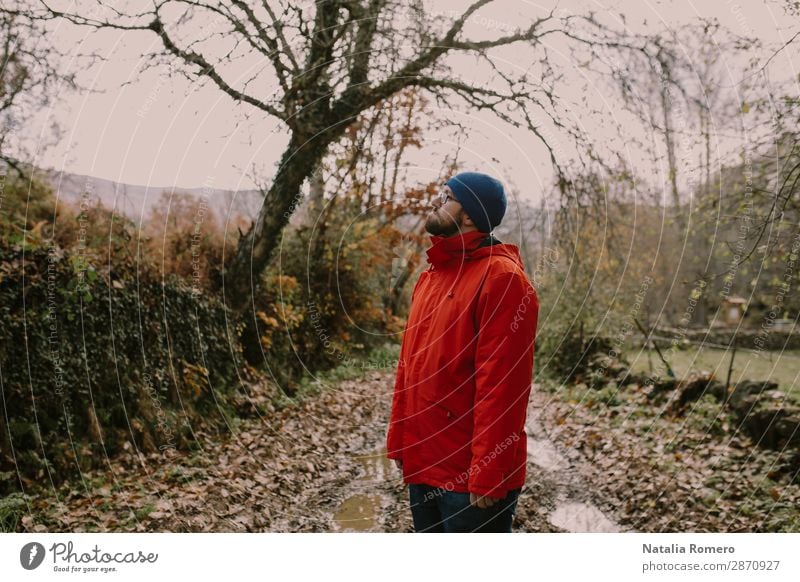 Boy in a red coat is on a mud road Lifestyle Happy Relaxation Leisure and hobbies Vacation & Travel Adventure Hiking Sports Retirement Man Adults Landscape