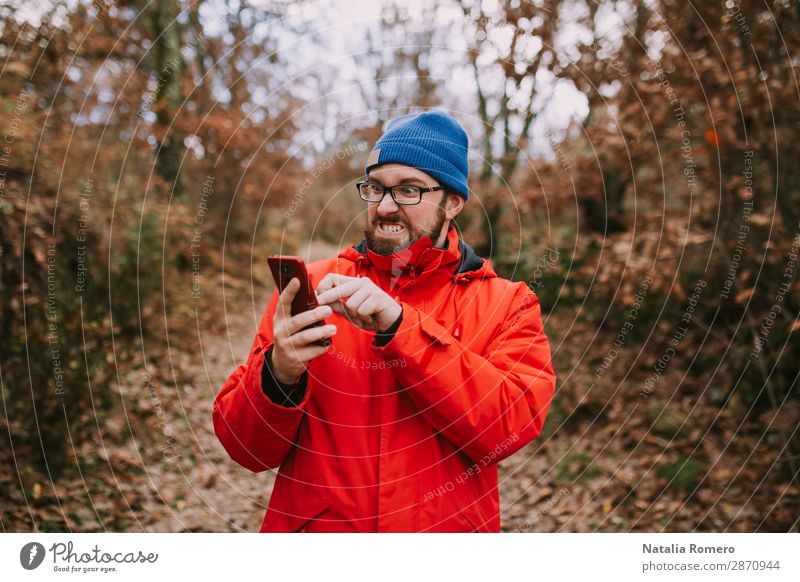 Young man fights with his mobile phone in the middle of the forest trying to make it work Lifestyle Beautiful Vacation & Travel Tourism Trip Adventure Mountain