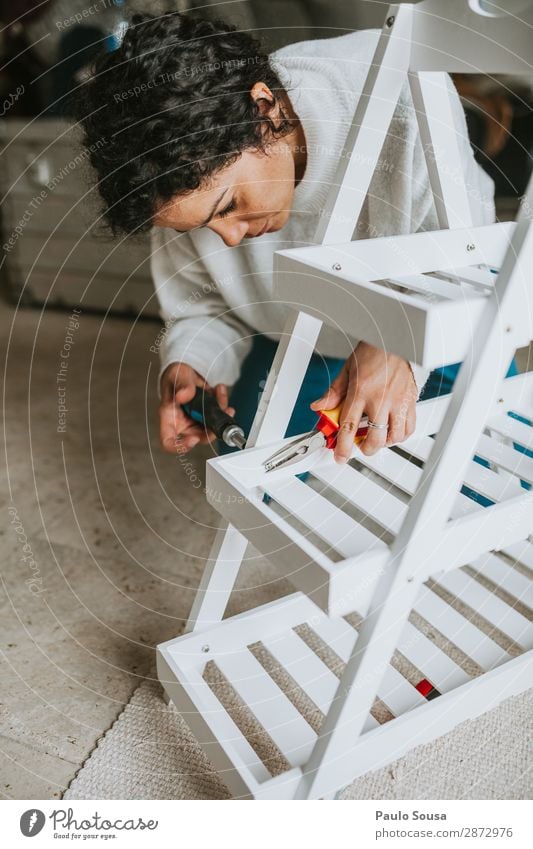 Woman assembling furniture at home Lifestyle House (Residential Structure) Arrange Human being Feminine Young woman Youth (Young adults) 1 18 - 30 years Adults