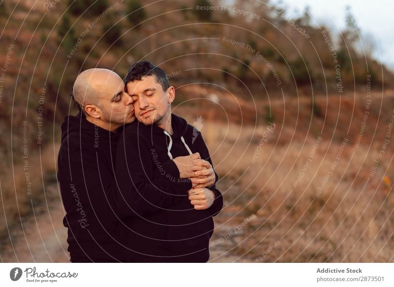 Men hugging on road on hill Homosexual Couple Embrace Hill Silhouette Street Valley Love embracing Picturesque Vantage point Fog Mountain Lanes & trails