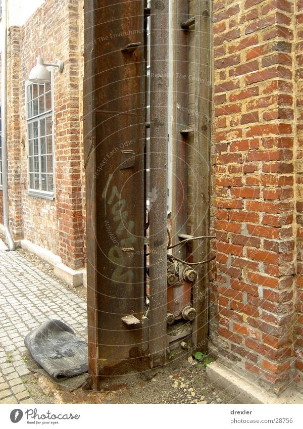 steel wheel Wall (barrier) Steel Column Architecture Graffiti Interior courtyard